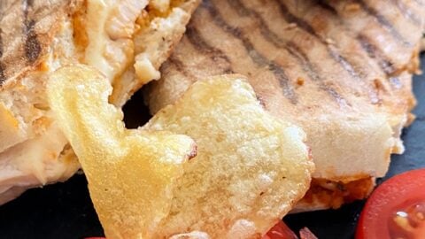 Cheesy Chicken Panini Sandwich. Grilled Chicken sandwiches filled with melting cheese, using leftover cooked chicken. Serve warm for lunch or supper.