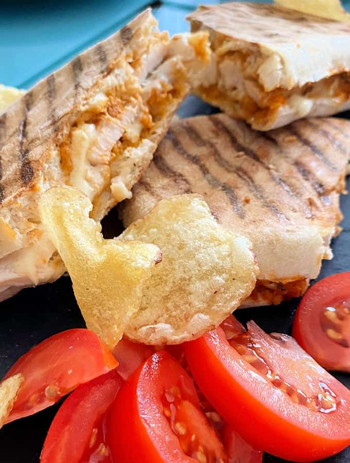 Cheesy Chicken Panini Sandwich. Grilled Chicken sandwiches filled with melting cheese, using leftover cooked chicken. Serve warm for lunch or supper.