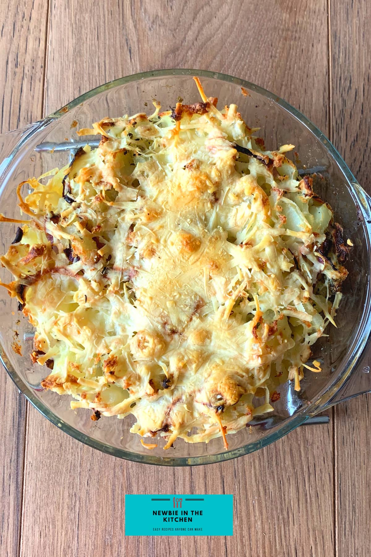 Cheesy Oven-Baked Garlic Potatoes. A simple, easy side dish recipe, with fluffy potatoes, cheese, and onions, baked in a tasty garlic and herb mix. The perfect cheesy potato bake!