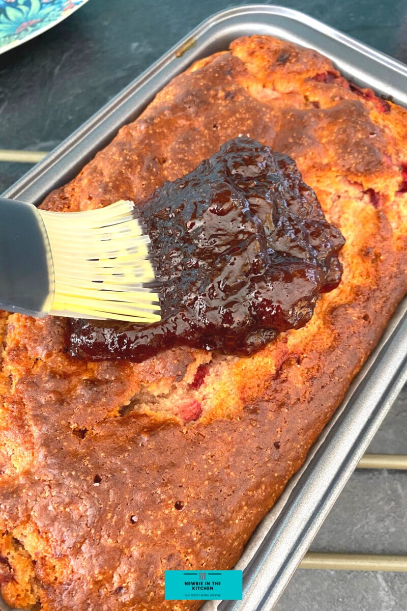 Easy Strawberry French Yogurt Cake, applying the jam glaze